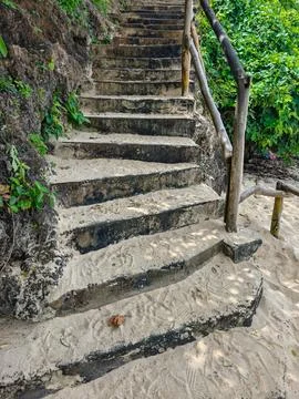 Rustic Stone Staircase Covered in Sand Leading Up a Coastal Cliff Stock Photos