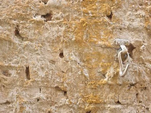 Rustic stone wall with metal hook Stock Photos