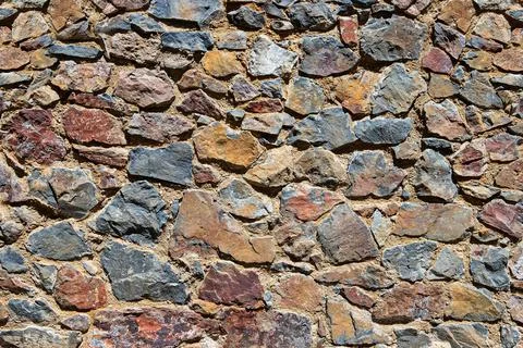 Rustic stone wall for texture Stock Photos