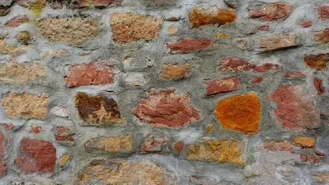Rustic Stone Wall With Textured Colors and Patterns Stock Photos