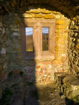 Rustic stone wall with window and sunlight Stock Photos