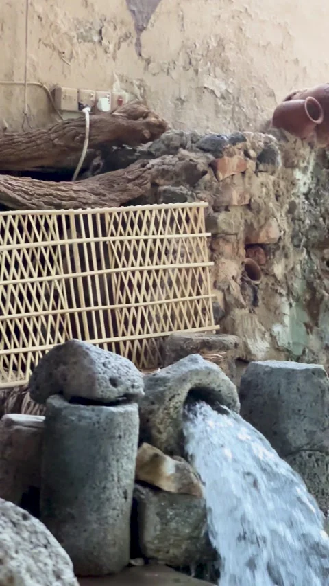 Rustic Stone Well and Clay Pot Water Fountain Stock Footage 344177571