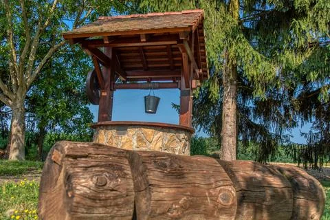 Rustic stone well with bucket and drinking water. Photos