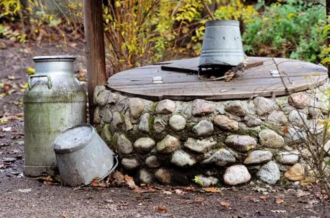 Rustic stone well, can and bucket Stock Photos
