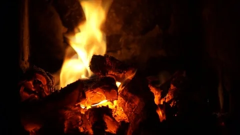 In a rustic stove a hot fire burns. Heat fireplace, background Stock Footage