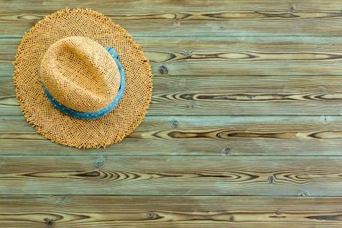 Rustic straw sunhat on old weathered pine Stock Photos