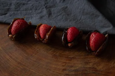 Rustic Strawberry-Stuffed Dates with Moody Lightin Stock Photos