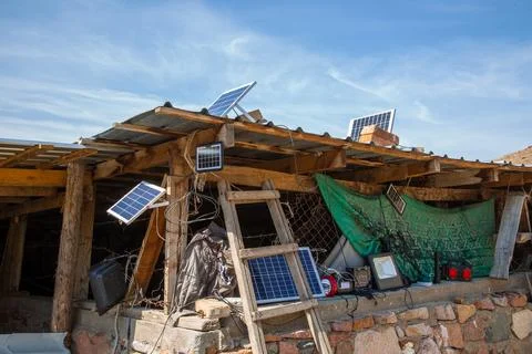 Rustic Structure with Solar Panels and Off-Grid Electronics Stock Photos