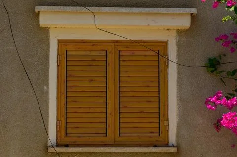 Rustic style aged window at rural home wall. Stock Photos