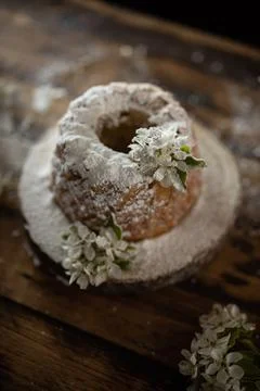 Rustic style apple bundt cake with powdered sugar on old wooden table Stock Photos