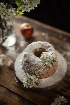 Rustic style apple bundt cake with powdered sugar on old wooden table Stock Photos