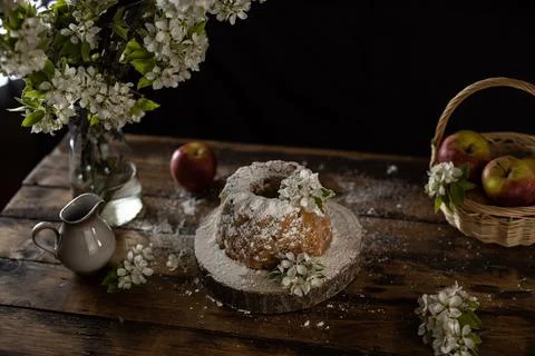 Rustic style apple bundt cake with powdered sugar on old wooden table Stock Photos