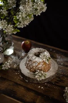 Rustic style apple bundt cake with powdered sugar on old wooden table Stock Photos