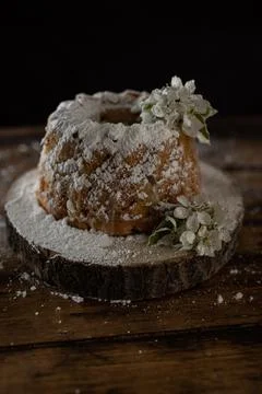 Rustic style apple bundt cake with powdered sugar on old wooden table Stock Photos