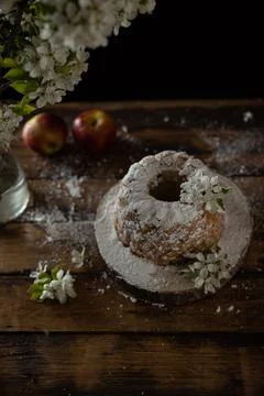 Rustic style apple bundt cake with powdered sugar on old wooden table Stock Photos