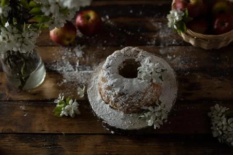 Rustic style apple bundt cake with powdered sugar on old wooden table Stock Photos