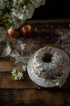 Rustic style apple bundt cake with powdered sugar on old wooden table Stock Photos
