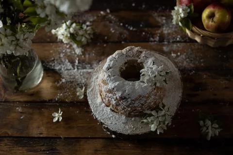 Rustic style apple bundt cake with powdered sugar on old wooden table Stock Photos