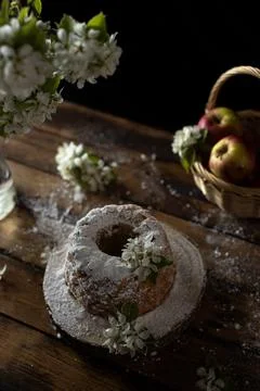 Rustic style apple bundt cake with powdered sugar on old wooden table Stock Photos