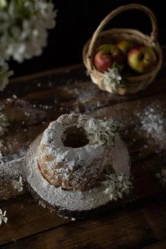 Rustic style apple bundt cake with powdered sugar on old wooden table Stock Photos