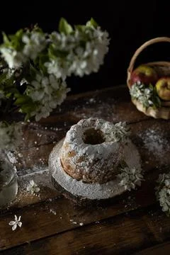 Rustic style apple bundt cake with powdered sugar on old wooden table Stock Photos