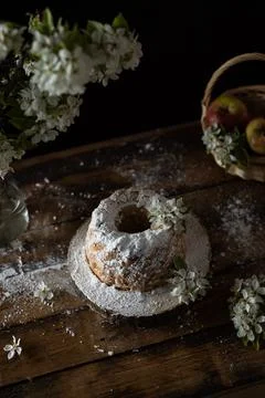 Rustic style apple bundt cake with powdered sugar on old wooden table Stock Photos
