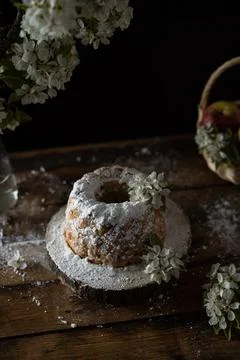 Rustic style apple bundt cake with powdered sugar on old wooden table Stock Photos