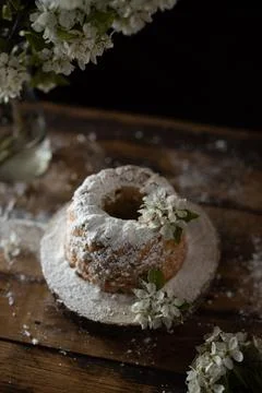 Rustic style apple bundt cake with powdered sugar on old wooden table Stock Photos