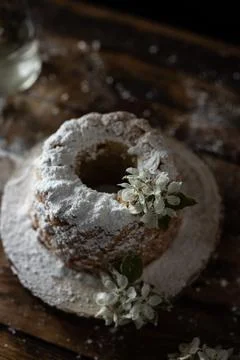 Rustic style apple bundt cake with powdered sugar on old wooden table Stock Photos