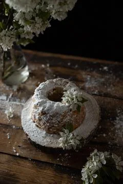 Rustic style apple bundt cake with powdered sugar on old wooden table Stock Photos