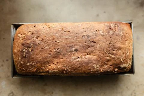 Rustic style whole grain bread loaf perfectly placed on a wooden cutting bo.. Stock Photos