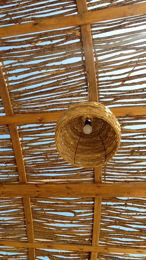 A rustic-style woven rattan pendant lamp Stock Footage 336208424