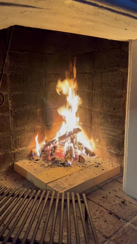 Rustic Swedish fireplace with glowing flames in relaxing vertical video Stock Footage 316771878