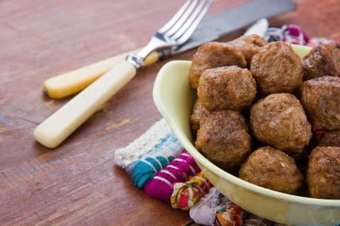 Rustic table with bowl of meatballs Stock Photos