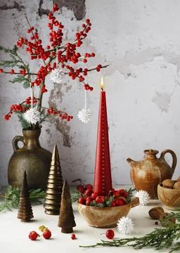 Rustic table decoration with red candle on a festive arrangement. Burning Advent 스톡 사진