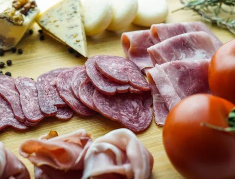 Rustic table of Iberian sausages and cheeses Stock Photos