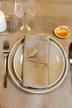 Rustic table setting with linen napkin and floral decoration Stock Photos