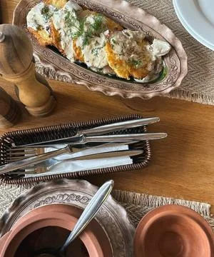 Rustic Table Setting with Potato Pancakes and Dill Sauce Plus Ceramic Soup Dish Stock Photos