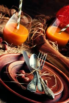 Rustic table setting for Thanksgiving Day: pottery, vintage appliances, straw Stock Photos
