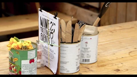 Rustic table setting with wine tasting event menu and repurposed tin can decor Stock Footage 326369528