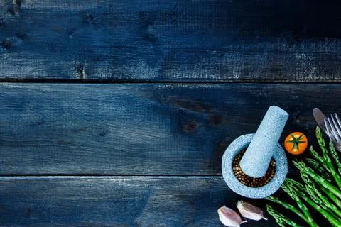 Rustic table with various colorful spices and vegetables Stock Photos