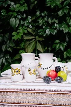Rustic tableware and fresh fruit on outdoor table Stock Photos