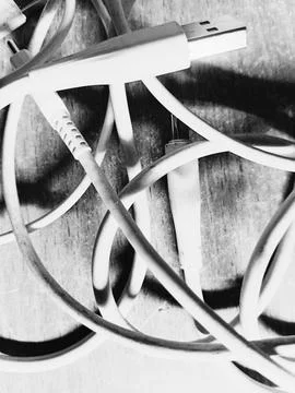 Rustic tangled usb cables on wood background Stock Photos