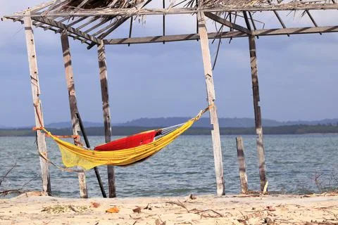 Rustic tent with hammock inside the beach. Deserted beach of Mangue Seco; Jan Stock Photos