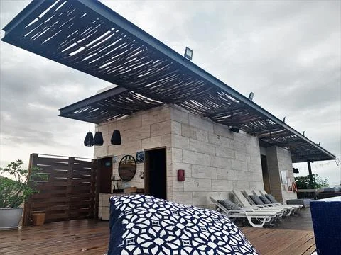 Rustic terrace on the rooftop of the hotel with pool Stock Photos