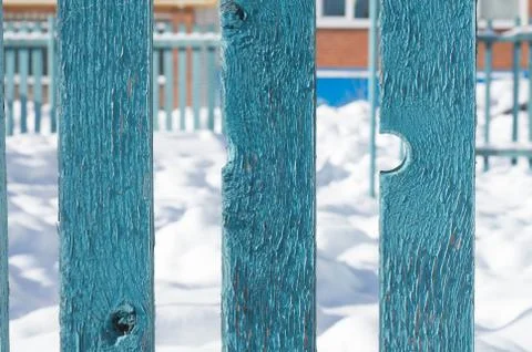 Rustic texture of old  painted  fence closeup.  house in the background Stock Photos