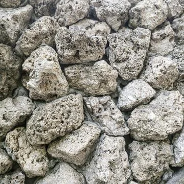 Rustic textured stone wall background with natural rough gray rocks Stock Photos