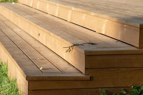 Rustic timber decking stairs on a backyard lawn Stock Photos