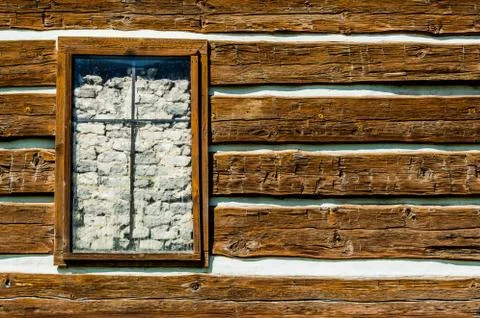 Rustic timber wall with window covered inside by bricks Stock Photos