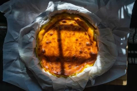 Rustic top view of a Basque cheesecake with beautiful sunlight and shadow fallin 스톡 사진